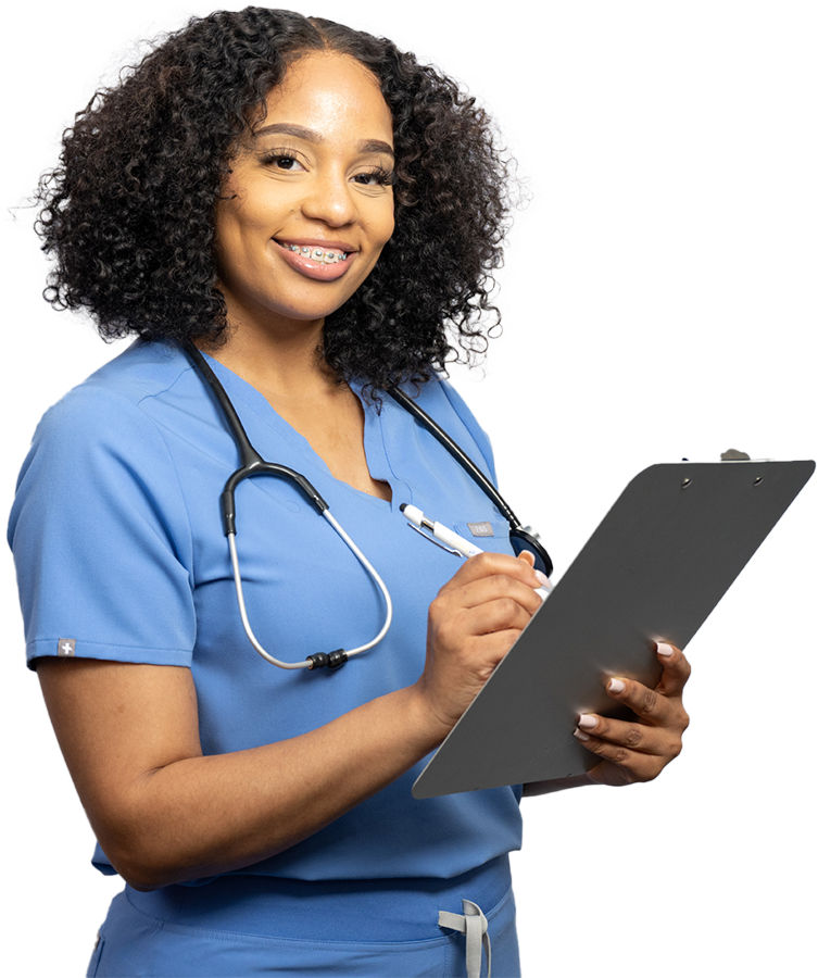 Female healthcare worker in scrubs smiling holding a clipboard and pen
